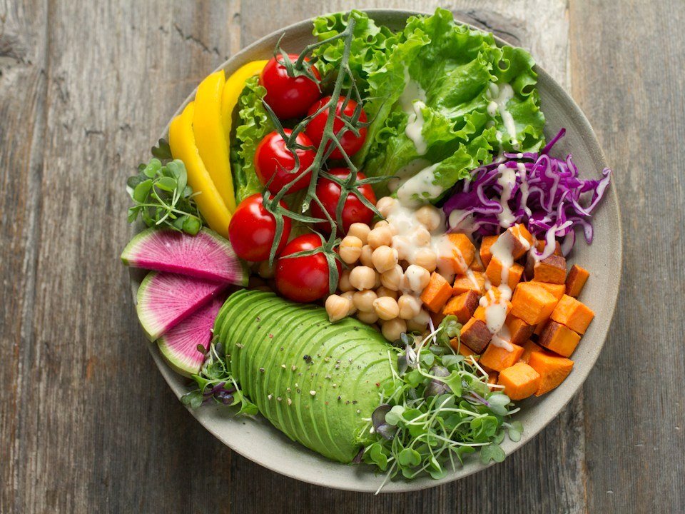 Concept photo: colorful harvest bowl with roasted sweet potato, greens, and chickpeas